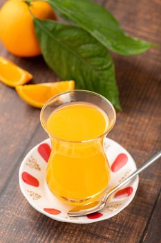 Winter drink orange oralet or oralette in a thin-waisted glass tea glass