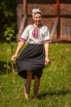 young woman in ukrainian national costume outdoors