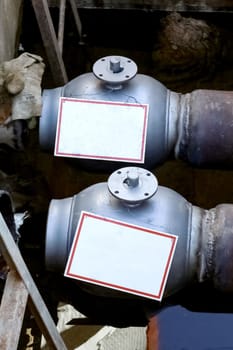Insulated pipes for hot water and valve underground close up