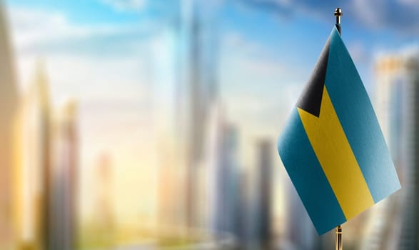 Small flags of the Bahamas on an abstract blurry background.