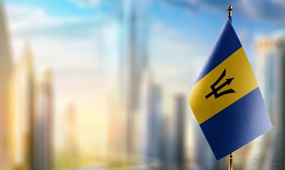 Small flags of the Barbados on an abstract blurry background.