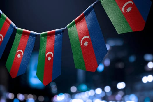 A garland of Azerbaijan national flags on an abstract blurred background.