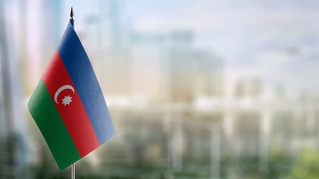 Small flags of the Azerbaijan on an abstract blurry background.