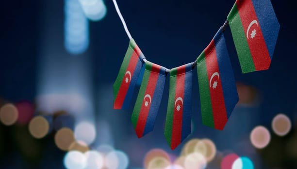 A garland of Azerbaijan national flags on an abstract blurred background.