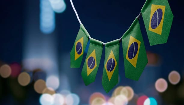 A garland of Brazil national flags on an abstract blurred background.
