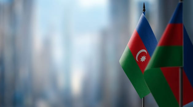 Small flags of the Azerbaijan on an abstract blurry background.