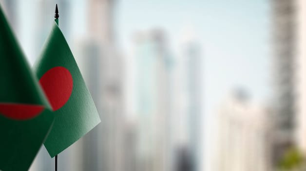 Small flags of the Bangladesh on an abstract blurry background.