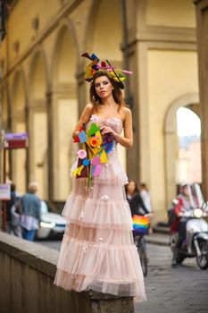 a bride in a pink wedding dress with an unusual bouquet and decoration in Gorova in Florence, Italy.