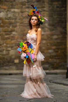 a bride in a pink wedding dress with an unusual bouquet and decoration in Gorova in Florence, Italy.