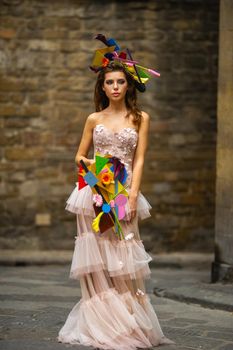 a bride in a pink wedding dress with an unusual bouquet and decoration in Gorova in Florence, Italy.