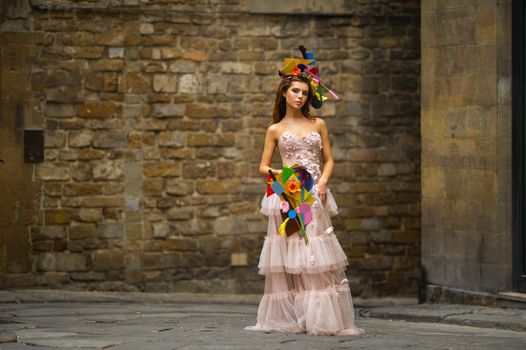 a bride in a pink wedding dress with an unusual bouquet and decoration in Gorova in Florence, Italy.