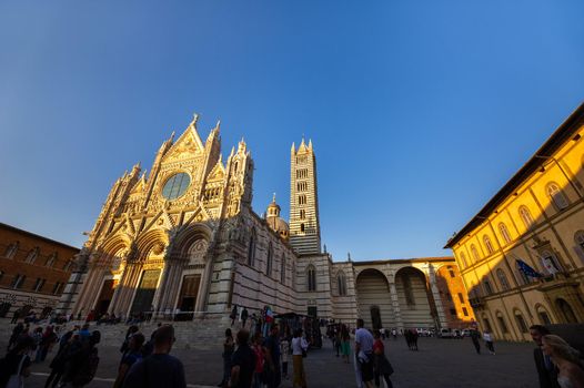 SIENA, ITALY. October 13, 2018: Sunset and view of Siena's Cathedral of Santa Maria Assunta Duomo di Siena in Siena.