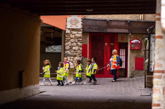 Sirmione, Italy-October 9, 2018: children march in formation in the town of Sirmione near Scaligera Castle.