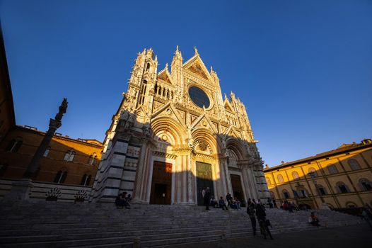 SIENA, ITALY. October 13, 2018: Sunset and view of Siena's Cathedral of Santa Maria Assunta Duomo di Siena in Siena.