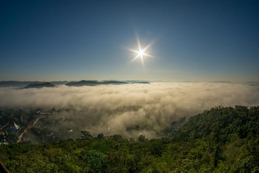 Morning fog covers Lamphun, Thailand, view from the viewpoint of Wat Phra That Pha Temple