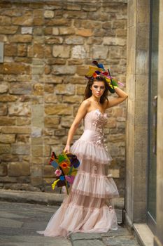 a bride in a pink wedding dress with an unusual bouquet and decoration in Gorova in Florence, Italy.