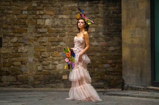 a bride in a pink wedding dress with an unusual bouquet and decoration in Gorova in Florence, Italy.