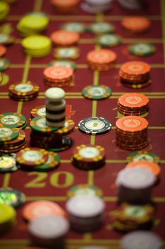 close-up of casino chips on the red table.