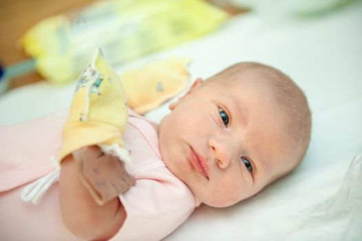 a newborn baby on the first day of its birth in the maternity hospital.