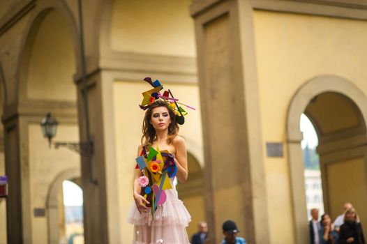 a bride in a pink wedding dress with an unusual bouquet and decoration in Gorova in Florence, Italy.