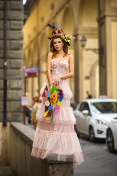 a bride in a pink wedding dress with an unusual bouquet and decoration in Gorova in Florence, Italy.