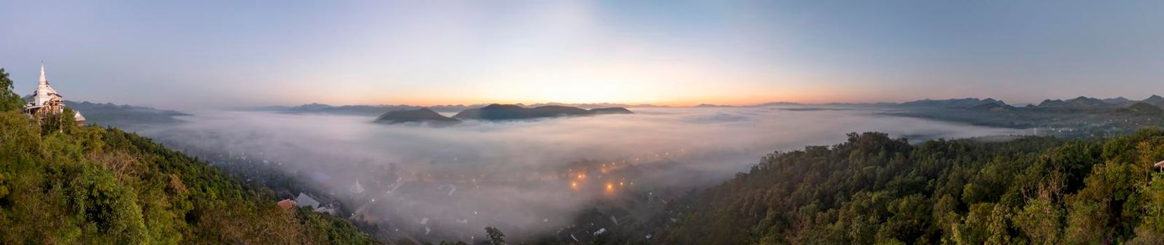 Fog covers the city of Lamphun, Thailand, view from the viewpoint of Wat Phra That Pha Nam