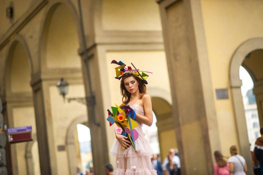 a bride in a pink wedding dress with an unusual bouquet and decoration in Gorova in Florence, Italy.