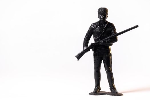 Vintage toy black soldier isolated on white background.