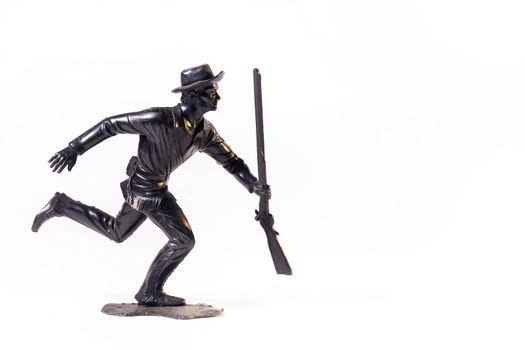 Vintage toy black soldier isolated on white background.
