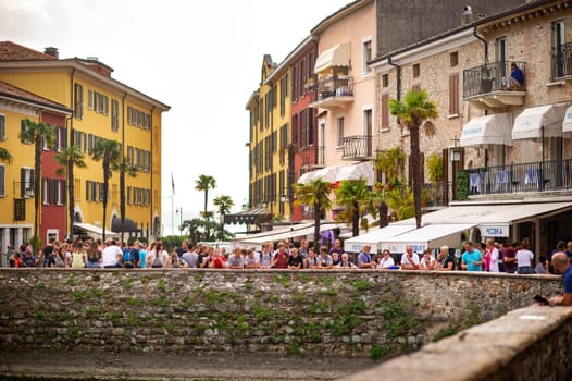 Sirmione, Italy-October 9, 2018: People relax in the town of Sirmione near the castle of Scaligera.