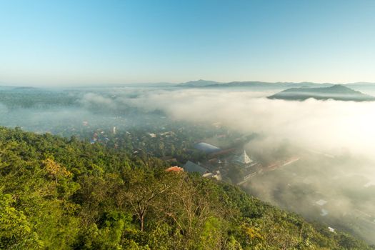 Morning fog covers Lamphun, Thailand, view from the viewpoint of Wat Phra That Pha Temple