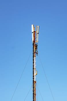 Telephone antenna on blue sky background close up