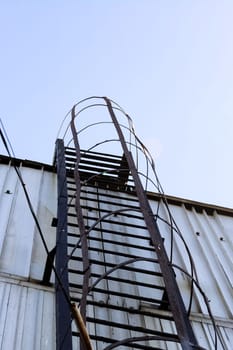 Fire metal staircase on a building wall close up