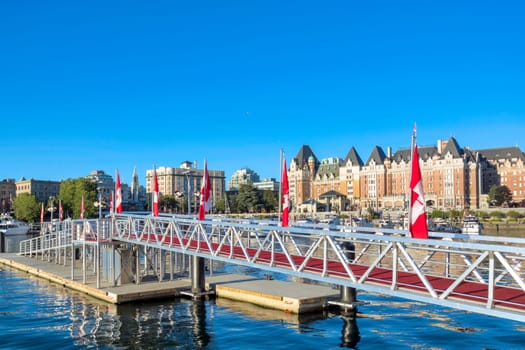 Metal ramp to a pier decorated with canadian flags at Victoria City center