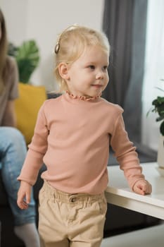 Deaf child girl with cochlear implant studying to hear sounds - recovery after cochlear Implant surgery and rehabilitation