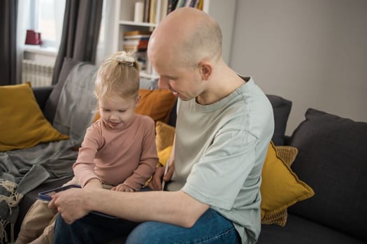 Deaf child girl with cochlear implant studying to hear sounds - recovery after cochlear Implant surgery and rehabilitation