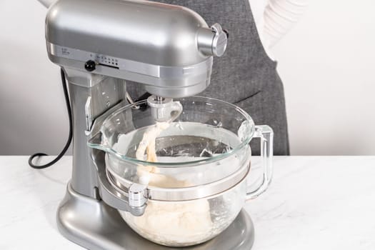 Mixing bread dough in a stand-alone kitchen mixer to bake patriotic cinnamon twists.