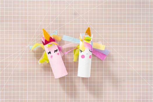 Flat lay. Making a unicorn out of the toilet paper roll and craft paper.