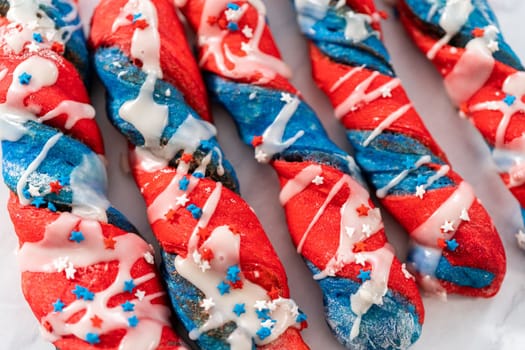 Patriotic cinnamon twists drizzled with a white glaze and decorated with star sprinkles.