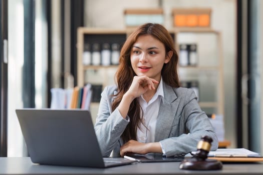 Business Lawyer consulting online on laptop while working at office