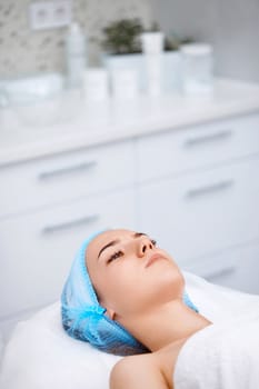 young beautiful woman at spa salon. female face with healthy smooth soft skin