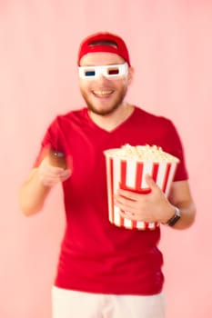 smiling man in 3d glasses using console watching movie isolated on pink background