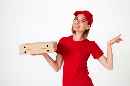smiling pizza delivery woman in uniform holding pizza boxes on white background