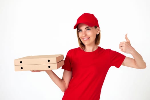 friendly pizza delivery woman in uniform with pizza boxes showing thumbs up on white background