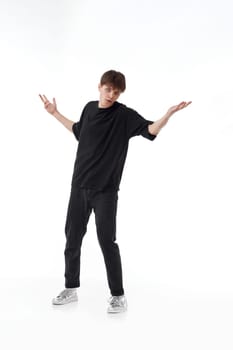 young man in black t-shirt and jeans dancing on white background. Full length