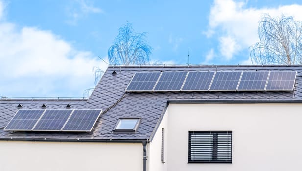 solar panels for the production of electricity from the sun on the roof of a family house. High quality photo