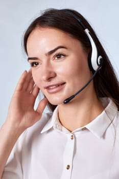 Portrait of beautiful woman in headset is consulting clients online. Call center, business people concept