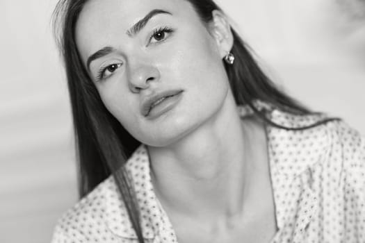 portrait of sexy brunette woman in pajamas. black and white