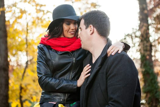 Beautiful happy couple in autumn park relaxing