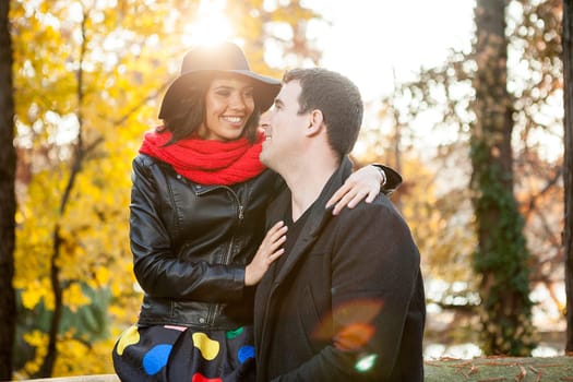 Beautiful happy couple in autumn park relaxing